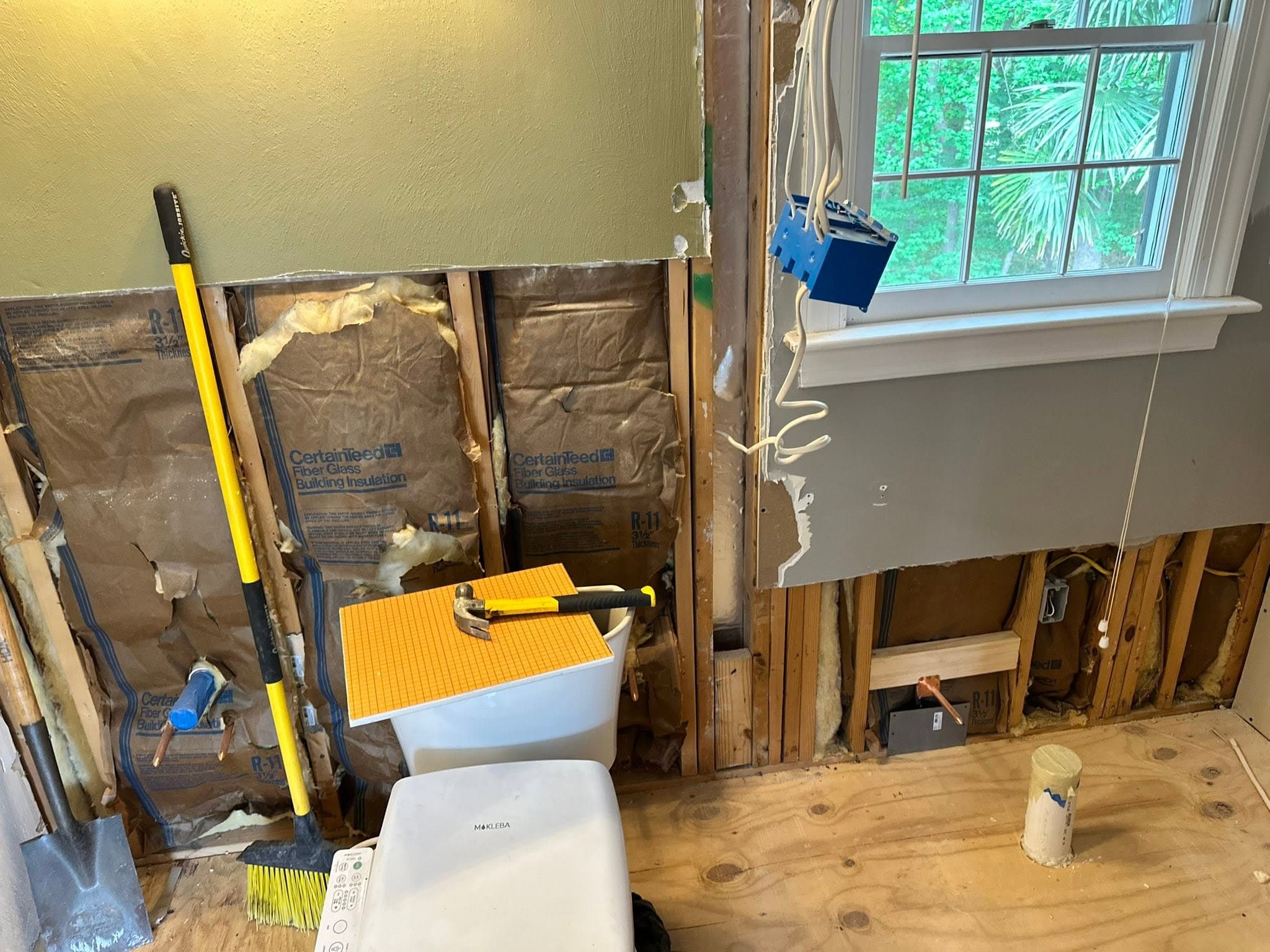 Bathroom gutted to the studs with rough plumbing exposed during a remodel in Portsmouth VA — Newman's Plumbing Service & Repair
