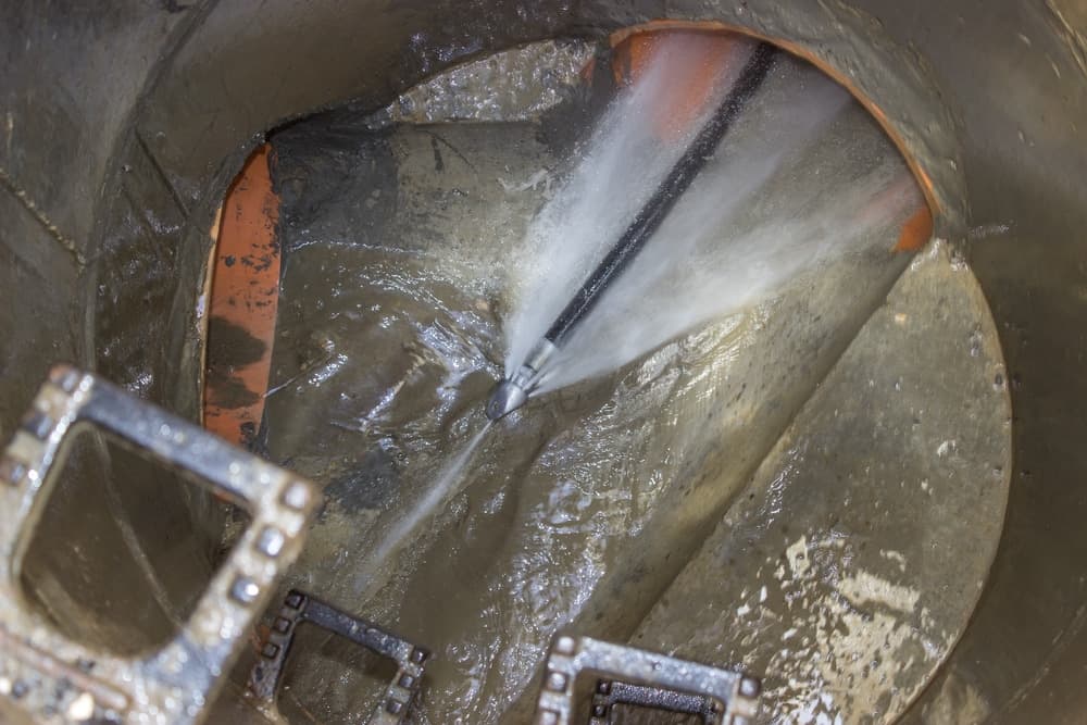 High pressure hydro jetting nozzle scouring grease and buildup from a sewer line in Portsmouth VA — Newman's Plumbing Service & Repair