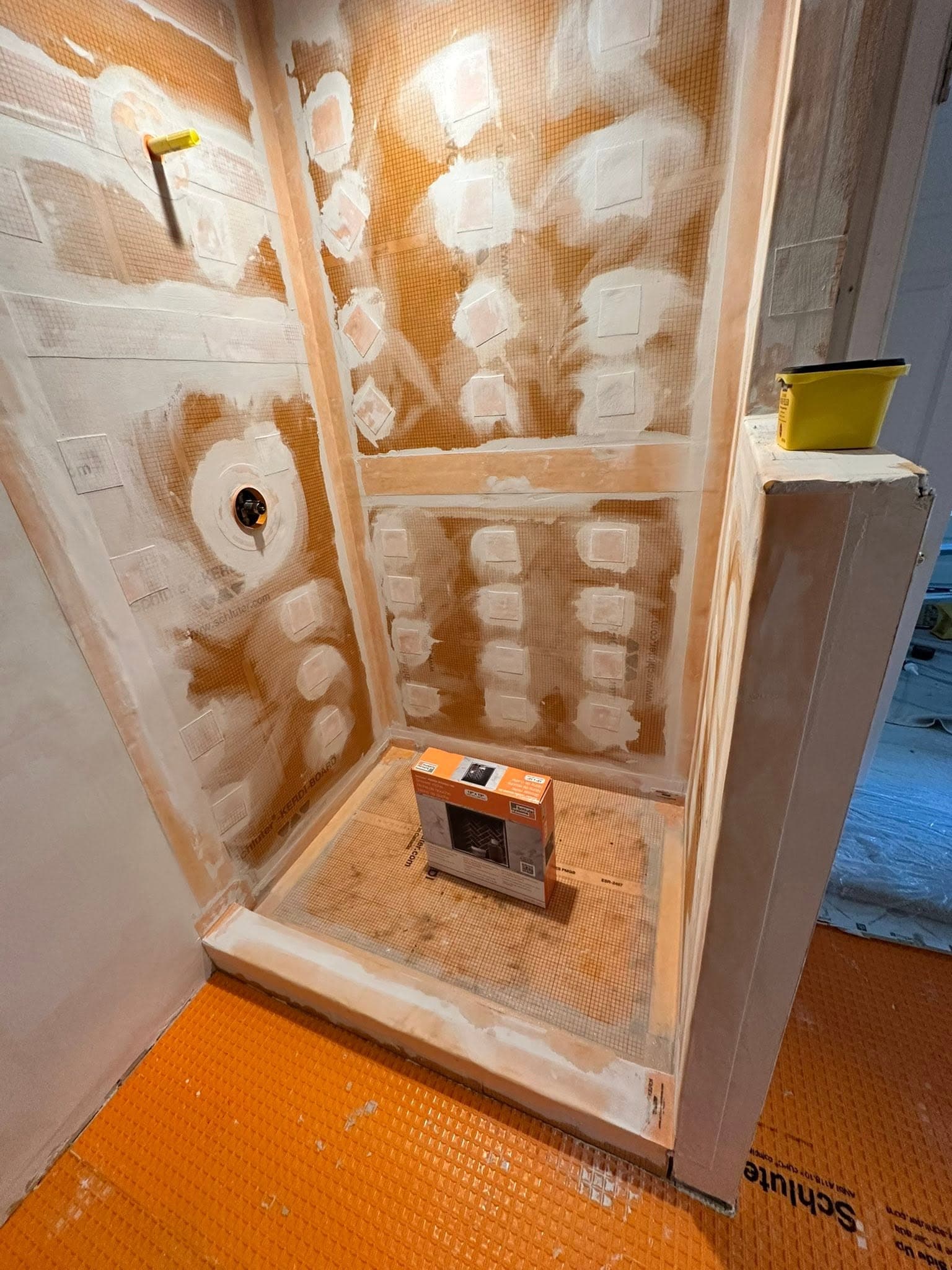 Waterproofing membrane being installed over a shower pan and walls before tile in Portsmouth VA — Newman's Plumbing Service & Repair