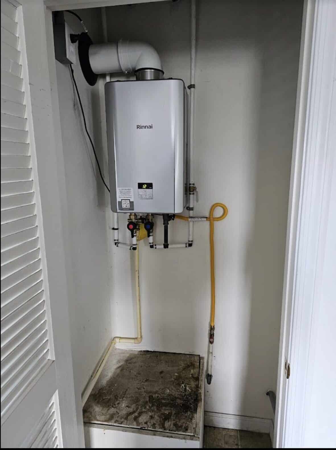 Newly installed tankless water heater with copper supply lines mounted in a Portsmouth VA home — Newman's Plumbing Service & Repair
